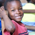 Uganda boy smile bill-wegener-NmVKiFkVdnM-unsp